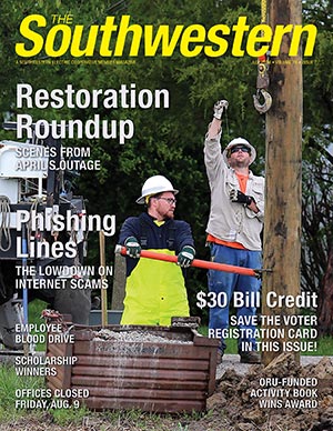 Journeyman linemen Braden Clark and Tyler Kunz make repairs on Rockwell Road in Madison County after an April storm interrupted power to 3,200 members. 