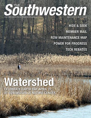 A view of two people walking through the wetlands of Watershed Nature Center.